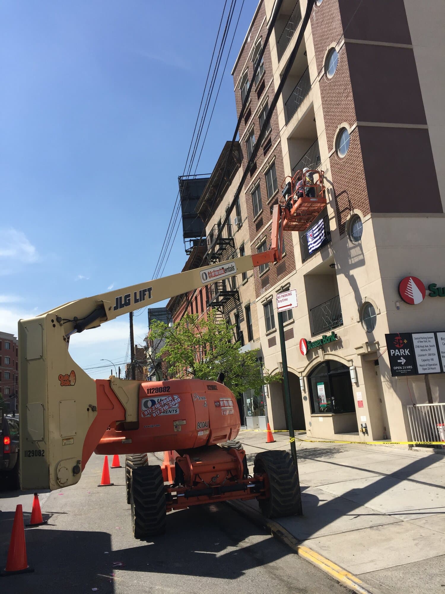 Licensed structural engineers on a boom lift inspecting a residential building addition in the Bronx, New York